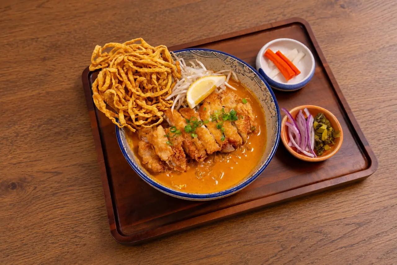 Chiang Mai Khao Soi with crispy chicken, coconut curry and a crisp noodle nest.