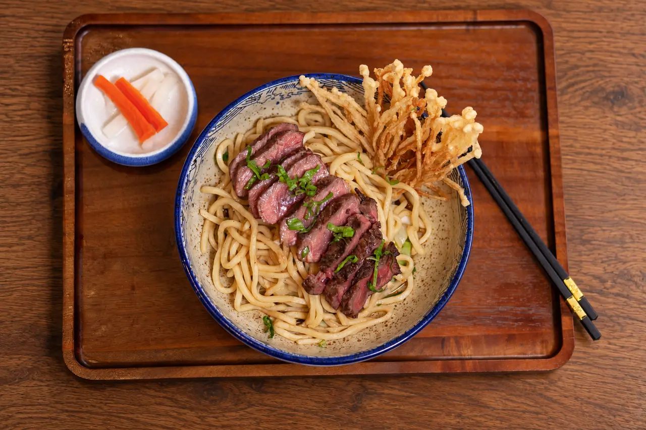 Jaew Hon Ribeye hand-tossed udon with ribeye and crispy enoki.